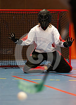 Floorball goalie against another team opponent during an important floorball championship game