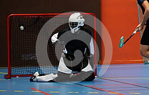 Floorball goalie against another team opponent during an important floorball championship game