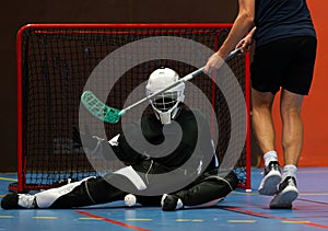 Floorball goalie defending the net at an important championship game