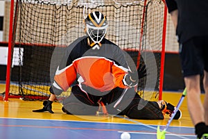 Floorball goalie defending the net at an important championship game