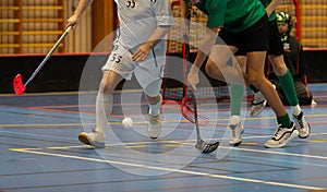 Floorball players competing against each other in a floorball championship game