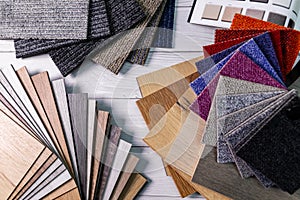 Flooring and furniture materials - colorful floor carpet and wooden laminate samples