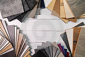 Flooring and furniture materials - floor carpet and wooden laminate samples with copy space photo