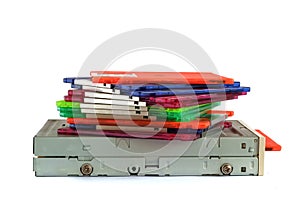 Floppy disk drive and diskettes on white background