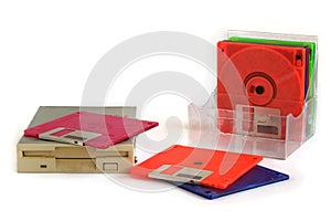 Floppy disk drive and diskettes on white background