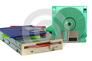 Floppy disk drive and diskettes on white background