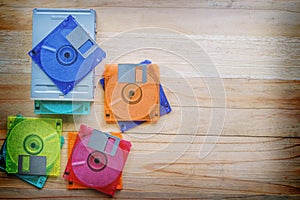 Floppy disk drive and diskettes on wooden table