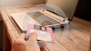 Floppy Disk and Notebook on wooden board