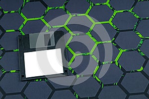 A floppy disk from an old computer placed on a black mouse pad