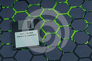 A floppy disk from an old computer placed on a black mouse pad