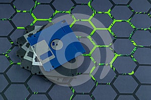 A floppy disk from an old computer placed on a black mouse pad