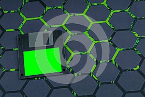 A floppy disk from an old computer placed on a black mouse pad