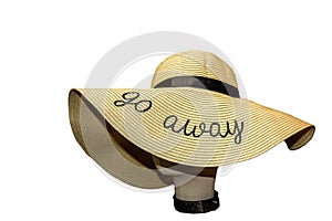 Floppy straw hat with black grossgrain ribbon and  Stay Away embroidered on it on store model head isolated on white-Room for Copy