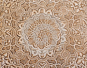 Floral and abstract design of plaster in the Nasrid palaces of the Alhambra in Granada, Spain