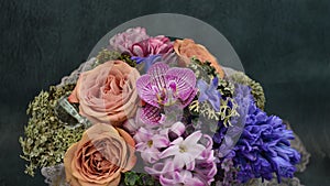Floral arrangement and decoration. Chic floral arrangement. Roses, hyacinth, moss, orchid. Floral design