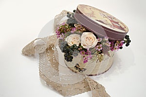 Floral arrangement and decoration. Round gift box filled with fresh flowers, roses and berries. gift the flowers