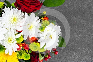 Floral arrangement of fresh flowers in the green wicker basket o