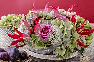 Floral arrangement with gloriosa superba, rose, hortensia and sedum flower