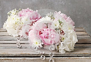 Floral arrangement with pink peonies, white chrysanthemums and g