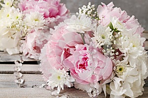 Floral arrangement with pink peonies, white chrysanthemums and g