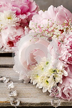 Floral arrangement with pink peonies, white chrysanthemums and g