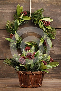 Floral arrangement with  skimmia Skimmia japonica, an evergreen shrub and fir twigs