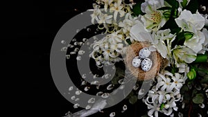 Floral arrangements and decoration. White floral mix on a black background. Alstroemeria, geocint and willow branches. Easter.