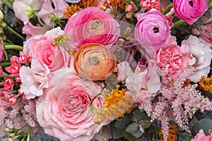 Floral backdrop, background. Flowers in bloom. Orange pink bouquet with roses close-up