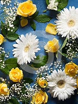 Floral background with yellow and white flowers on blue