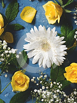 Floral background with yellow and white flowers on blue