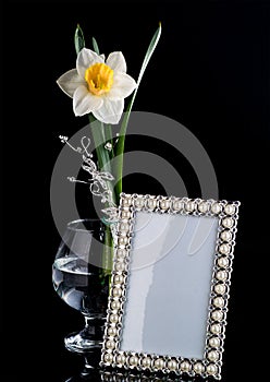 Floral composition with a frame and glass