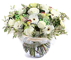 Floral composition in glass, transparent vase: White roses, orchids, white gerbera daisies, green peas. Isolated on white