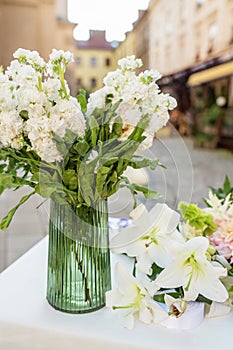 Floral decor for events. Vase of White Hydrangeas with Lilies on Display. Background