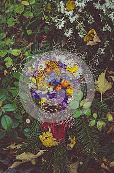 Floral decoration on grave during All Saints Day in the cemetery