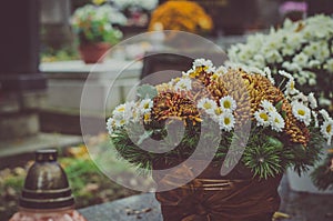 Floral decoration on grave during All Saints Day in the cemetery