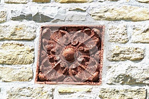 Floral decoration in a stone wall