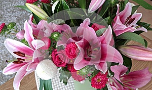 Floral display including Flashpoint pink and white Oriental Trumpet Lily closeup