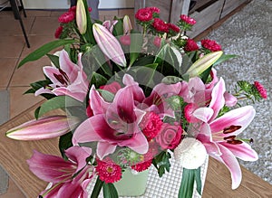 Floral display including Flashpoint pink and white Oriental Trumpet Lily closeup