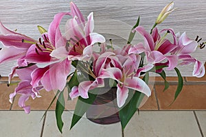 Floral display including Flashpoint pink and white Oriental Trumpet Lily closeup