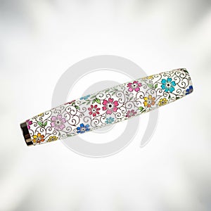 A floral-engraved nail stamping tool, floating in mid air horizontally on a solid white background