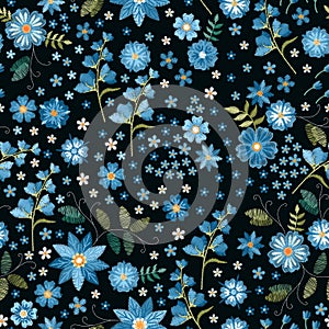 Floral fancywork. Embroidered  seamless pattern. Embroidery blue flowers on black background. Print for fabric and textile photo