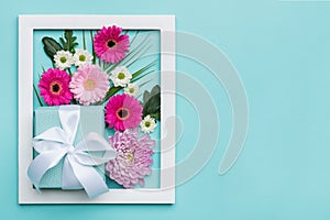 Floral flat lay minimal concept with beautifully wrapped present. Happy Mother`s Day.