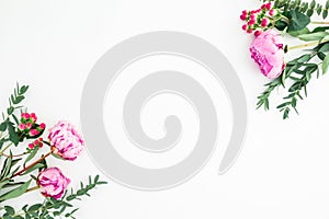 Floral frame composition with bouquets of pink peonies and eucalyptus branches on white background. Flat lay