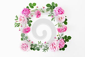 Composition with tulips flowers, cookies and cup of coffee on yellow background. Flat lay, top viewFloral frame made of pink roses