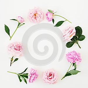 Floral frame made of pink roses and peonies on white background. Flat lay, Top view. Flower composition