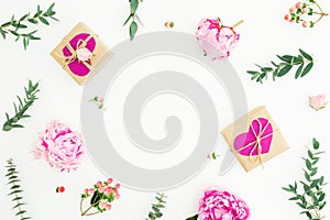 Floral frame of pink peonies, roses, hypericum and eucalyptus branches and gifts on white background. Valentine day composition. F
