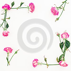 Floral frame of pink roses and buds on white background. Flat lay, Top view.