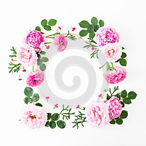 Floral frame of pink roses, peonies and leaves on white background. Flat lay, top view. Summer time flowers