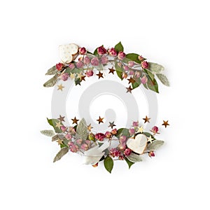 Floral frame wreath of dry rose flower buds, leaves and romantic decorations on white background mockup. Flat lay, top view