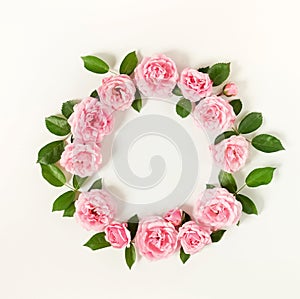 Floral frame wreath of pale pink roses flower buds and leaves on white background